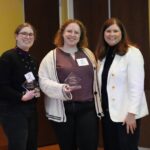 Anna Langdon and Eri Bentley receive their award from Kathy Blumenfeld